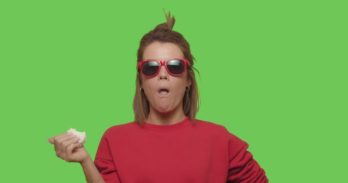 woman in sunglasses bites marshmallow