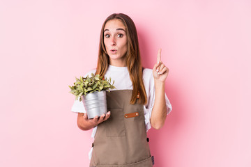 Young gardener caucasian woman isolated having some great idea, concept of creativity.