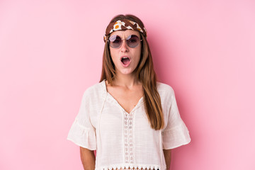 Young hipster caucasian woman isolated screaming very angry and aggressive.