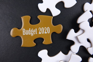 Budget 2020 printed on gold puzzle over white puzzle background