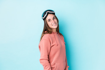 Young skier woman isolated looks aside smiling, cheerful and pleasant.