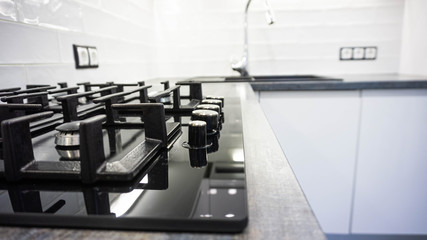 black glass hob built into a wooden worktop in the kitchen.