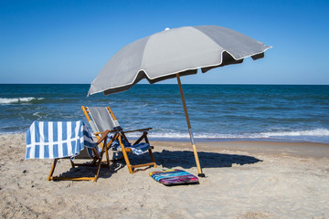 Beach chair with an umbrella