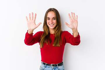 Young caucasian woman posing isolated  showing number ten with hands.
