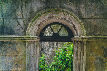 Ruined palast. Overgrown castle. Old window