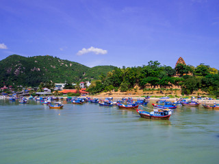 Fototapeta na wymiar View of the Cai River with the Ponagar Tower in the background. In Nha Trang, Vietnam