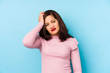 Middle age latin woman isolated being shocked, she has remembered important meeting.