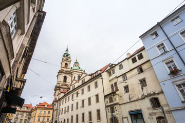 Fototapeta na wymiar St Nicholas Church, also called Kostel Svateho Mikulase, in Prague, Czech Republic, with its dome seen from Karmelitska street, in the Mala Strana District, in the old town