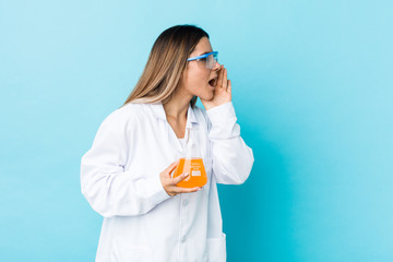 Young scientific woman shouting and holding palm near opened mouth.