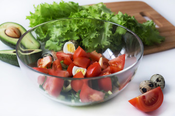 fresh vegetable and avocado salad in a glass cup