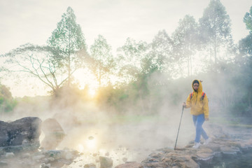 Obraz premium Blurry traveler and Morning fog over hot spring at Chae Son National Park, Thailand