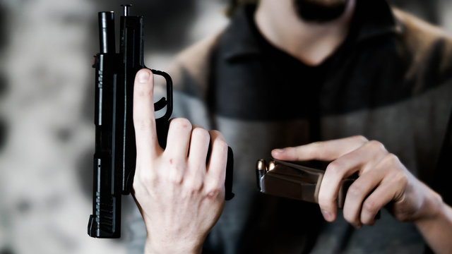 Man reloading a .45 caliber pistol with a dual-stacked magazine