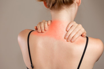 Woman having pain in neck, red highlight on pain spot. Redhead woman.