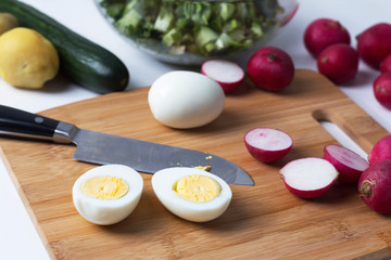 radish lies on a cutting board, next to a knife, cooking salad, cooking okroshka