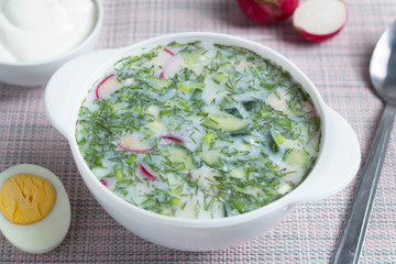 okroshka in a white plate on the table, proper nutrition, healthy eating concept
