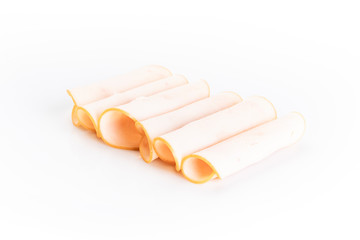 Poultry cold cuts cut into slices, rolled, isolated on white background, top view.
