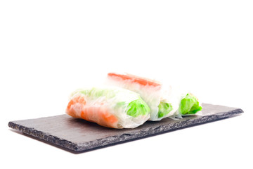 High key photo of Gỏi cuốn  or Vietnamese spring roll on slate plate. Traditional Vietnamese consisting of meat, prawn, vegetables, rice vermicelli and other ingredients wrapped in rice paper.