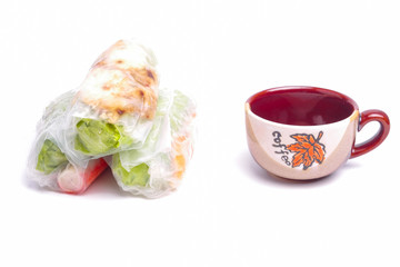 High key photo of Gỏi cuốn  or Vietnamese spring roll with a cup of coffee. Traditional Vietnamese consisting of meat, prawn, vegetables, rice vermicelli and other ingredients wrapped in rice paper.