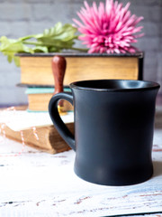 cup of coffee with flowers on wooden table