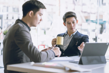 Business team discussing together in conference room during meeting at office. Teamwork, brainstorm and ideas concept. saleperson using tablet and presentation somthing to client.