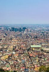 Obraz premium Aerial view of Naples in a hot summer day. Spaccanapoli, Naples Central Business District, Naples' train station (Napoli Centrale), and the Church of Santa Chiara are visible.