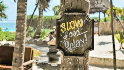 Sign posted near beach in Tulum, Mexico that describes the vibe of the area.