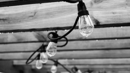 String of hanging lights at pergola for relaxing patio atmosphere in the cool evening.