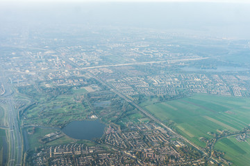 Amsterdam Schiphol,, a view of a city with a mountain in the background