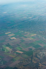 Amsterdam Schiphol,, a large stadium with green grass windmill farm