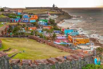 Colorful houses line the hillside over looking the beach in San Juan, Puerto Rico