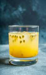 Old fahioned passion fruit cocktail on the rustic background. Selective focus. Shallow depth of field.