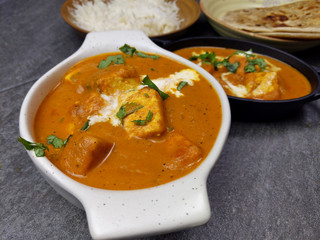 Top down view of Paneer Butter Masala , a rich and creamy Indian dish made of Paneer or Tofu in tomato and cream gravy.