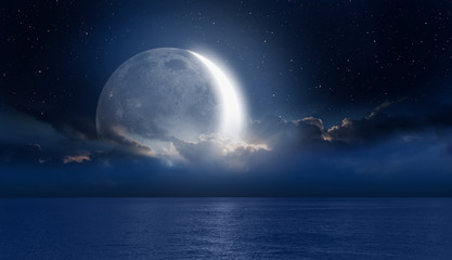 Fototapeta na wymiar Crescent moon over the tropical sea at night 