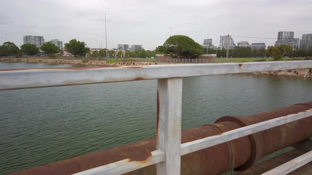Corroded old water pipe and fench next to a river in Sydney, Australia
