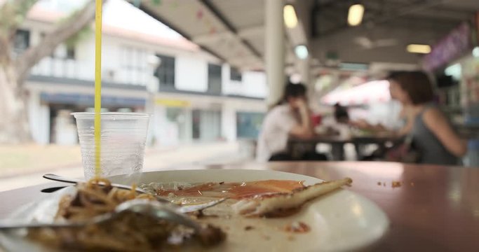 uncleared plate after eating at a hawker center