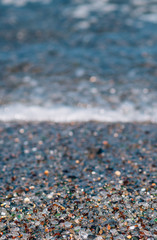 close up of glass beach at blue sea