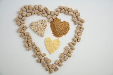 health heart made from pressed bran, rice briquette, ground bran on a white background