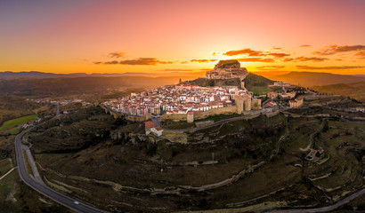 Aerial sunset view of Morella castle and town in central Spain with surrounding medieval walls,...