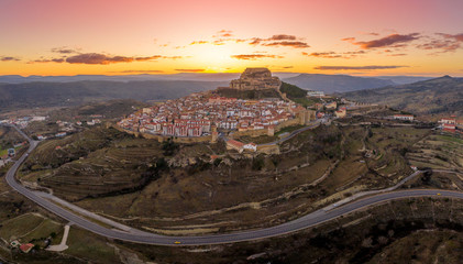 Aerial sunset view of Morella castle and town in central Spain with surrounding medieval walls,...