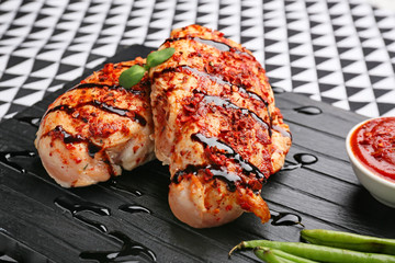 Cooked chicken fillet with sauce on table, closeup