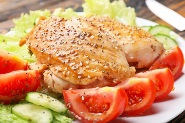 Cooked chicken fillet with vegetables on plate, closeup