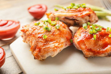 Cooked chicken thighs on table, closeup
