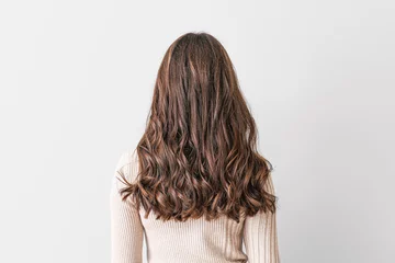Fotobehang Kapsalon Young woman with beautiful hair on light background  © Pixel-Shot