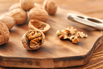 Tasty walnuts on wooden board