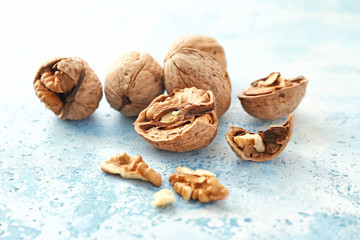 Tasty walnuts on color background