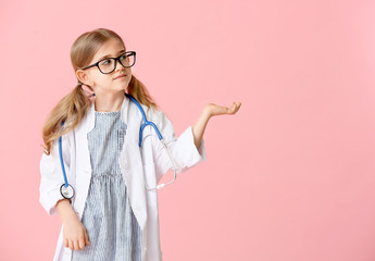 Cute little doctor on color background