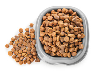 Bowl with dry pet food on white background