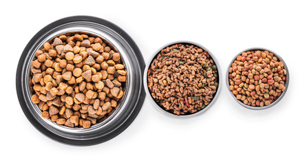 Bowls with dry pet food on white background
