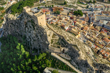 Fototapeta premium Aerial view of medieval restored Sax castle with two rectangular towers and two semi circular towers protecting the gate near Alicante Spain