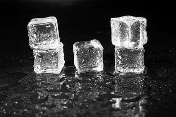 ice cubes on black table background.